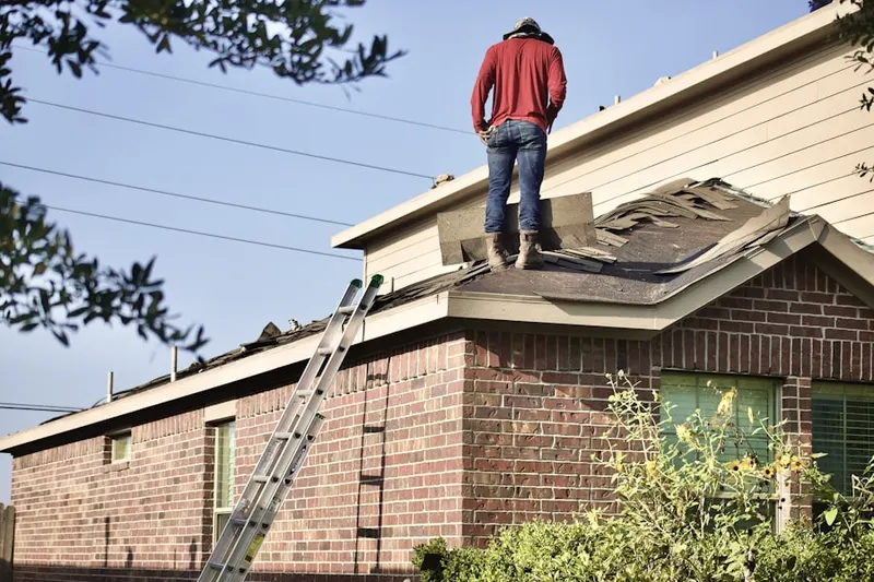 Professional roofer working on a residential roof in Camino